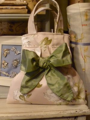 Beautiful pale pink handbag with white poppies and finished with green silk lining a detachable sash and an inside pocket.  Price: &pound;35.25